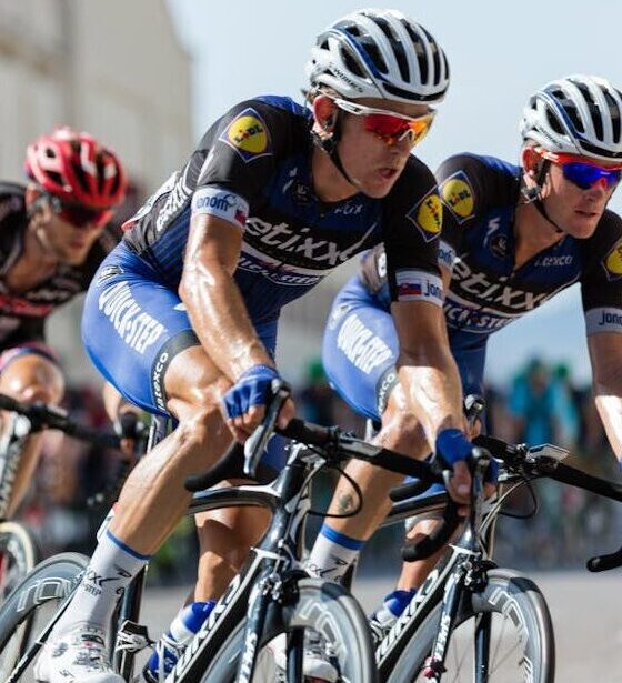 Competitive cyclists in a high-speed race, showcasing athleticism and teamwork.